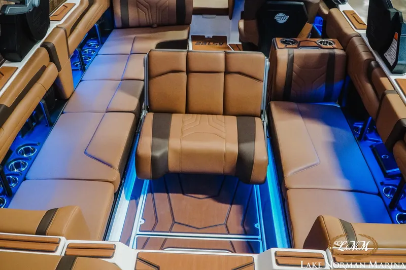Slide: The Image of Luxurious interior of 2026 Malibu Wakesetter 25 LSV with brown leather seating and blue LED lighting. - 23