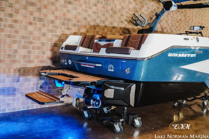 Slide: The Image of 2026 Malibu Wakesetter 25 LSV boat displayed indoors with blue lighting. - 5
