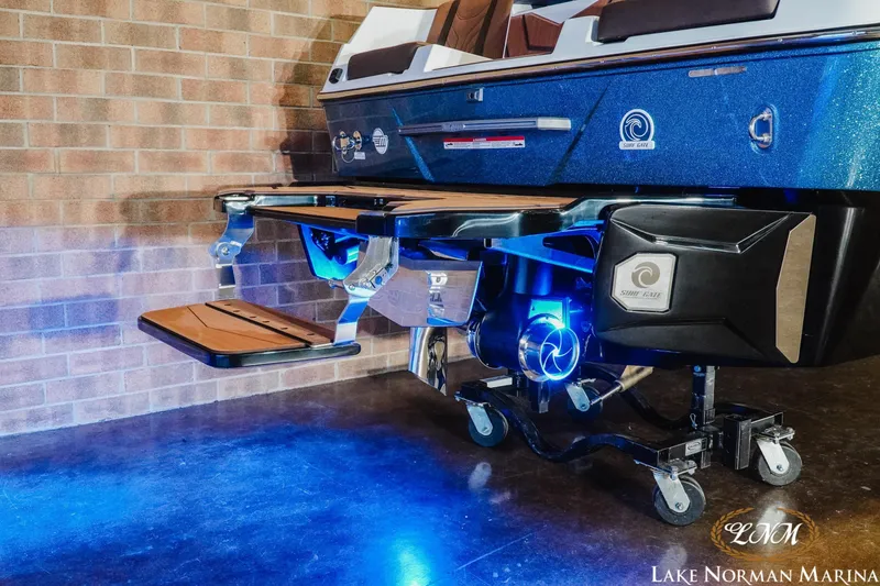 Slide: The Image of 2026 Malibu Wakesetter 25 LSV boat with illuminated swim platform and surf gate technology. - 6