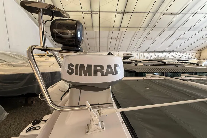 Slide: The Image of 2022 Axopar 28 Cabin with Simrad radar system in a covered storage facility. - 13
