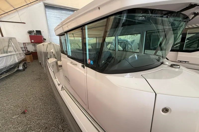 Slide: The Image of 2022 Axopar 28 Cabin boat in storage, showcasing sleek design and modern features. - 16