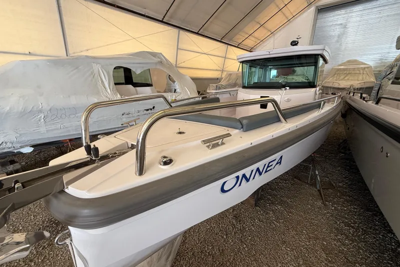 Slide: The Image of 2022 Axopar 28 Cabin boat in storage, featuring sleek design and modern cabin. - 26