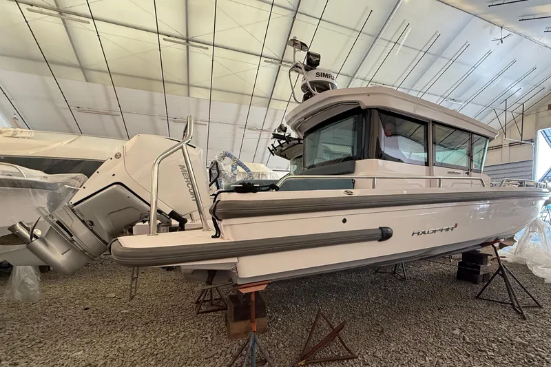 Slide: The Image of 2022 Axopar 28 Cabin boat in storage facility. - 5