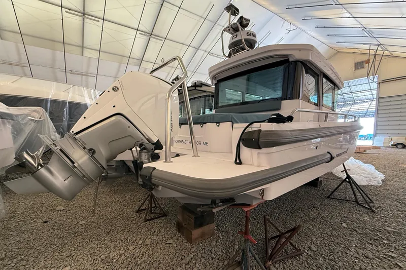 Slide: The Image of Axopar 28 Cabin 2022 in warehouse with outboard motor. - 6