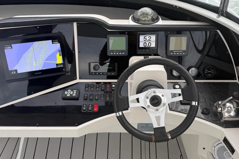 Slide: The Image of Control panel of a 2009 Carver 44 Sojourn yacht with navigation screens and steering wheel. - 17