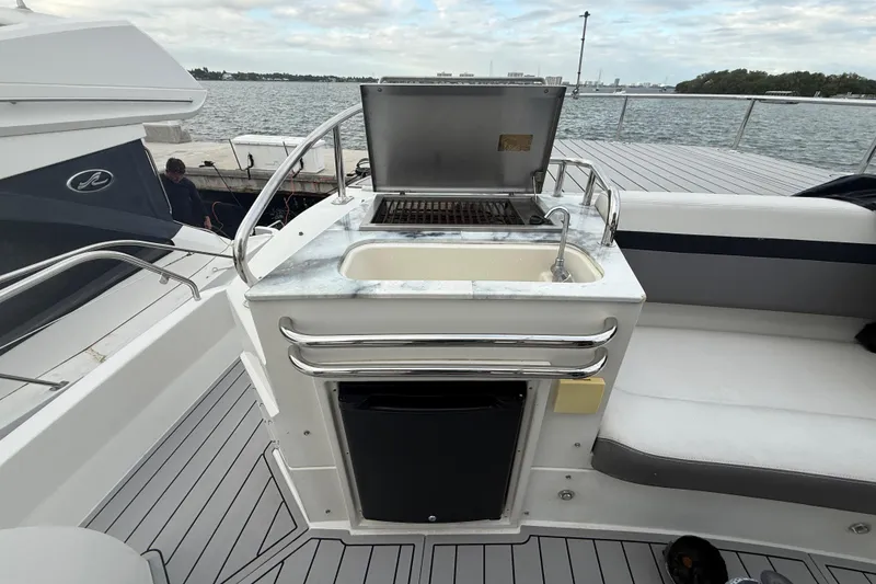 Slide: The Image of 2009 Carver 44 Sojourn yacht deck with grill and sink, overlooking water. - 24
