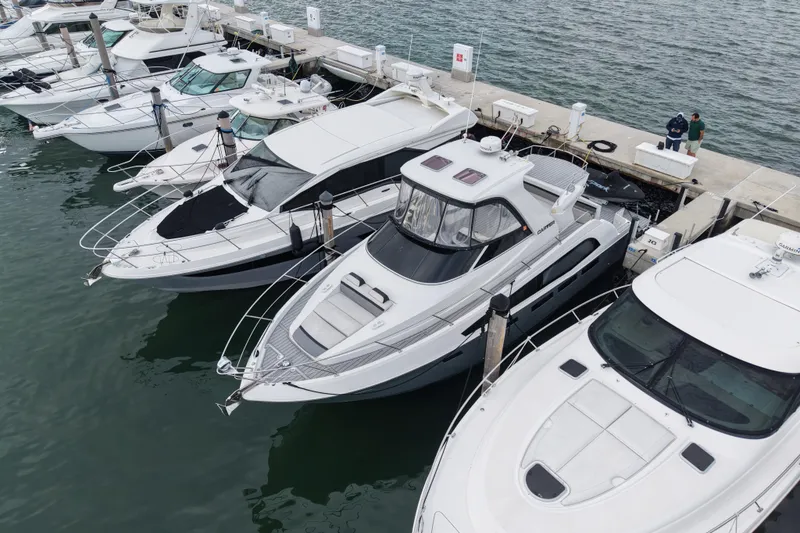 Slide: The Image of 2009 Carver 44 Sojourn yacht docked among other boats at a marina. - 3
