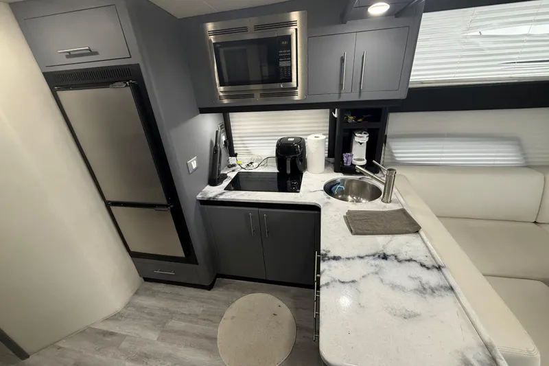Slide: The Image of Modern kitchen interior of 2009 Carver 44 Sojourn yacht with sleek appliances and marble countertops. - 30