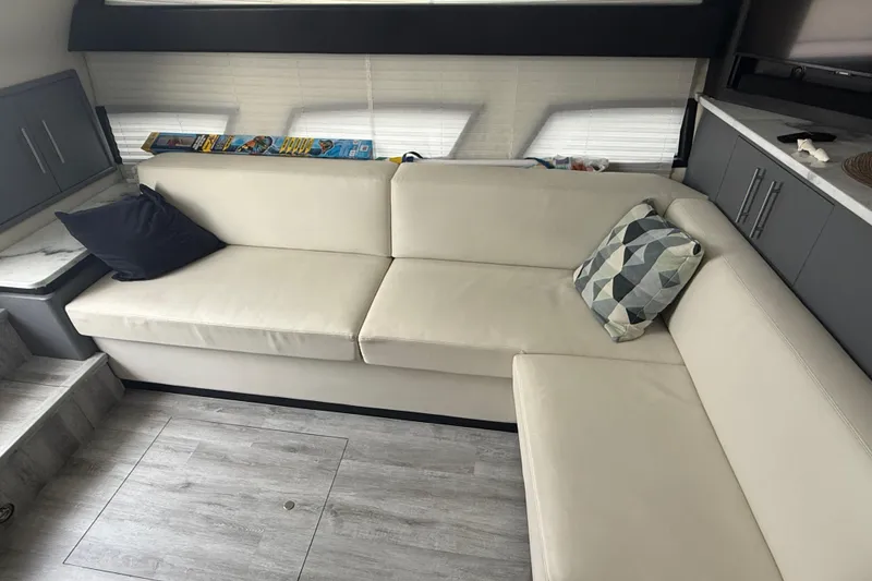 Slide: The Image of Luxurious interior of 2009 Carver 44 Sojourn yacht with modern beige seating and geometric pillows. - 31