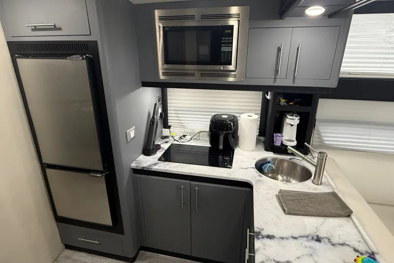 Slide: The Image of Modern kitchen in 2009 Carver 44 Sojourn yacht with appliances and marble countertop. - 33