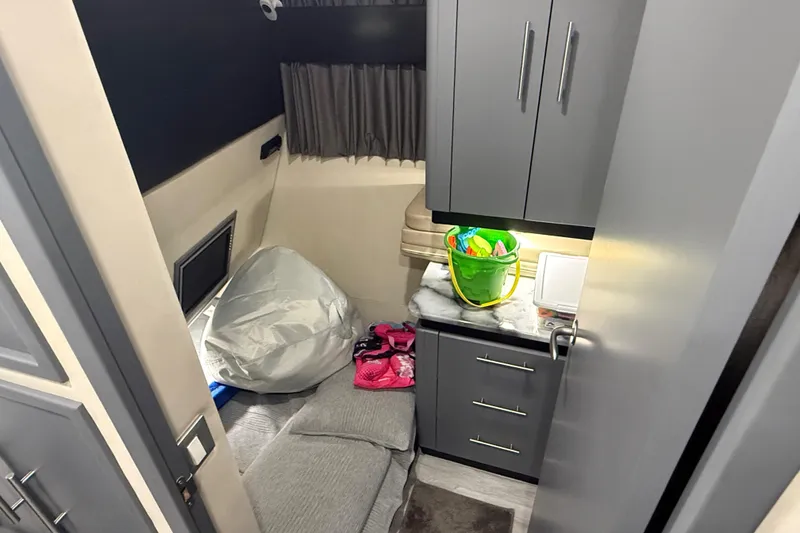 Slide: The Image of Interior cabin of 2009 Carver 44 Sojourn yacht with storage and seating area. - 35