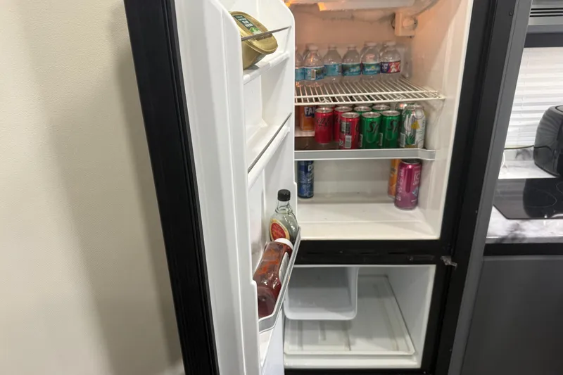 Slide: The Image of Open refrigerator in 2009 Carver 44 Sojourn yacht, stocked with drinks and condiments. - 42