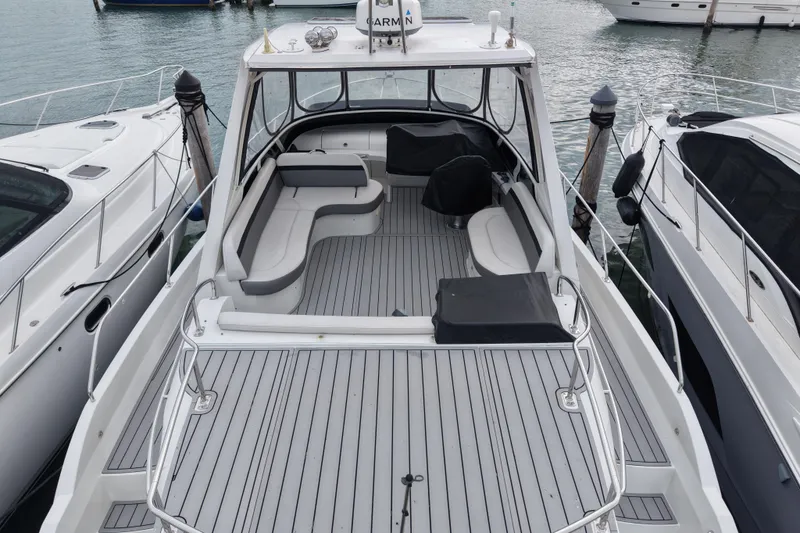 Slide: The Image of 2009 Carver 44 Sojourn yacht docked, featuring spacious deck and seating area. - 10
