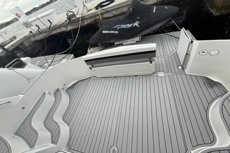 Slide: The Image of 2009 Carver 44 Sojourn yacht deck with sleek design and docked Sea-Doo Spark. - 23