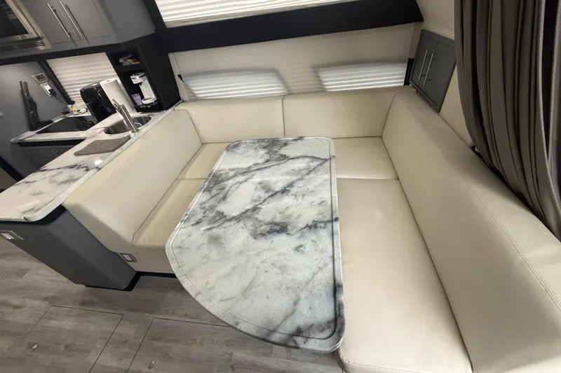 Slide: The Image of Luxurious interior of 2009 Carver 44 Sojourn with marble table and cream seating. - 29