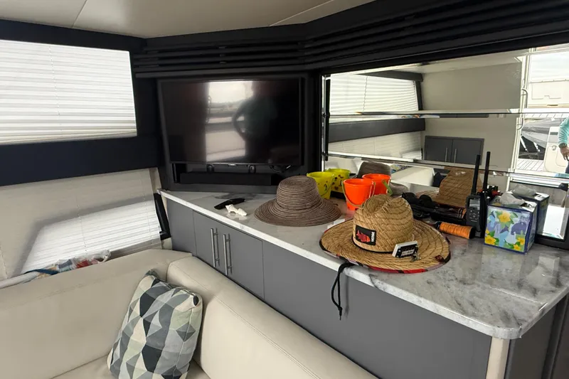 Slide: The Image of Interior of 2009 Carver 44 Sojourn yacht with hats and TV on marble counter. - 32