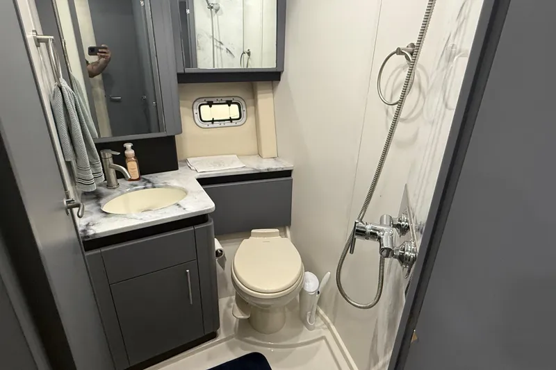 Slide: The Image of 2009 Carver 44 Sojourn yacht bathroom with shower, sink, and toilet. - 36