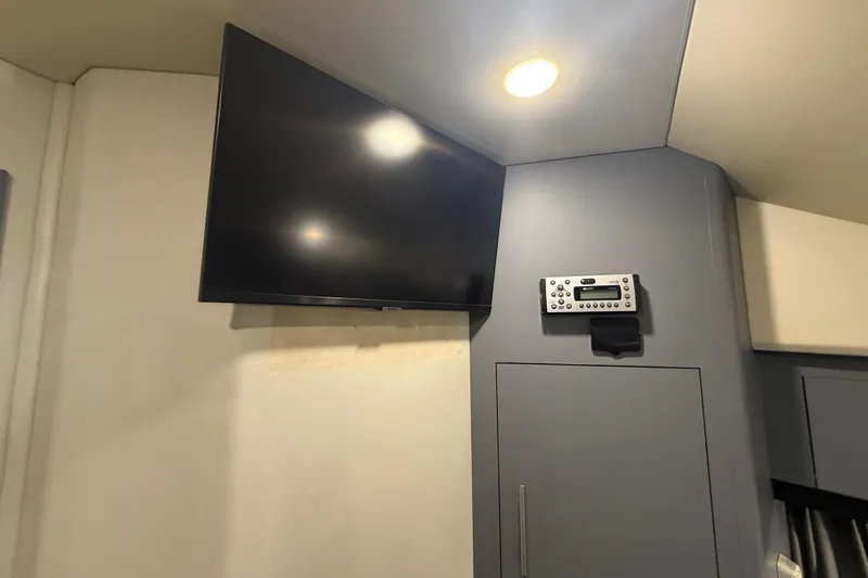 Slide: The Image of Interior of 2009 Carver 44 Sojourn with mounted TV and control panel. - 38