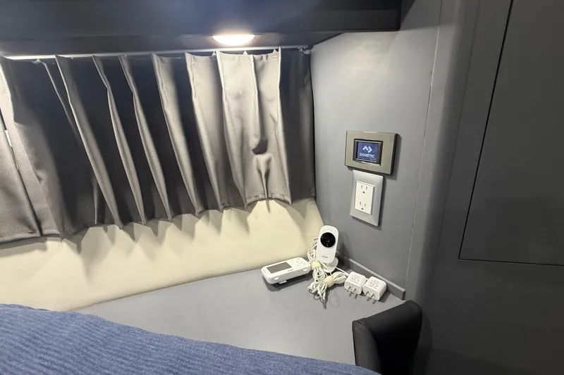 Slide: The Image of Interior of 2009 Carver 44 Sojourn with curtain, control panel, and electronic devices. - 39