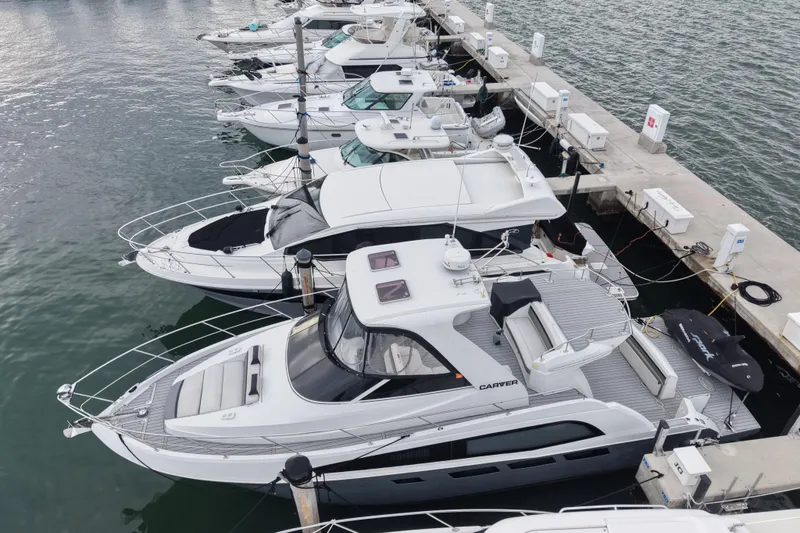 Slide: The Image of 2009 Carver 44 Sojourn yacht docked among other boats in a marina. - 4