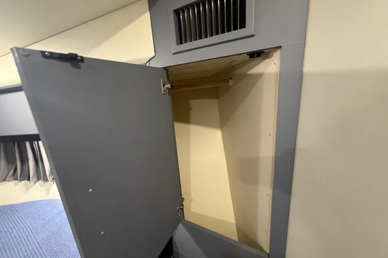 Slide: The Image of Open storage cabinet inside 2009 Carver 44 Sojourn yacht interior. - 40