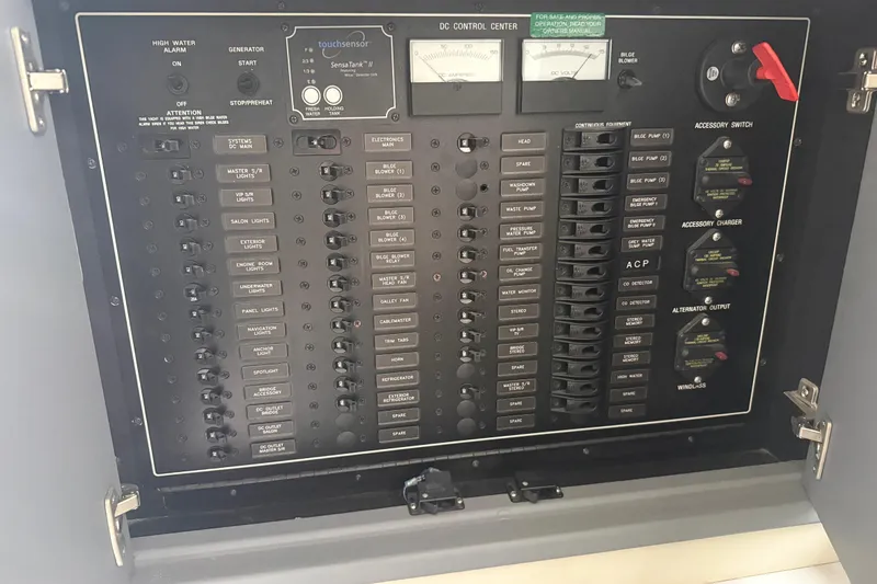 Slide: The Image of Electrical control panel of a 2009 Carver 44 Sojourn yacht, featuring various switches and gauges. - 43
