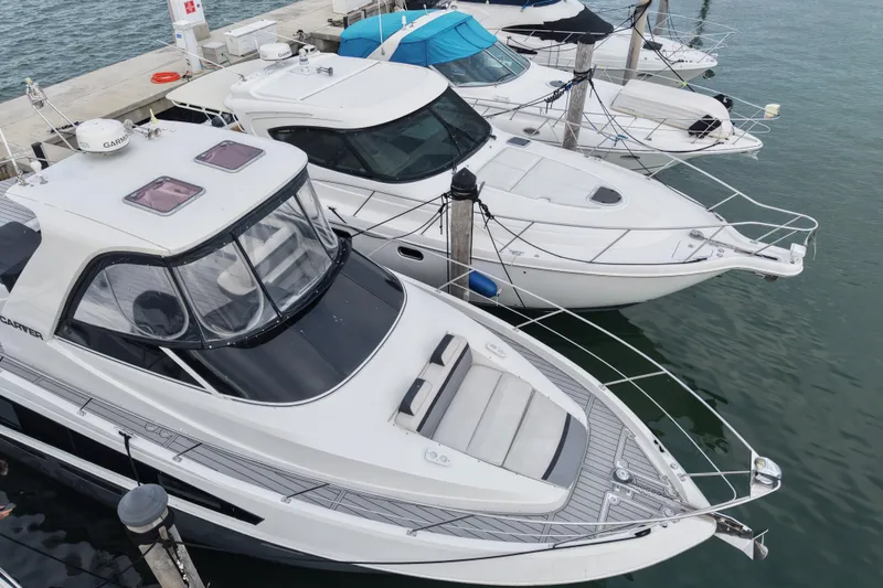 Slide: The Image of 2009 Carver 44 Sojourn yacht docked alongside other boats in a marina. - 5