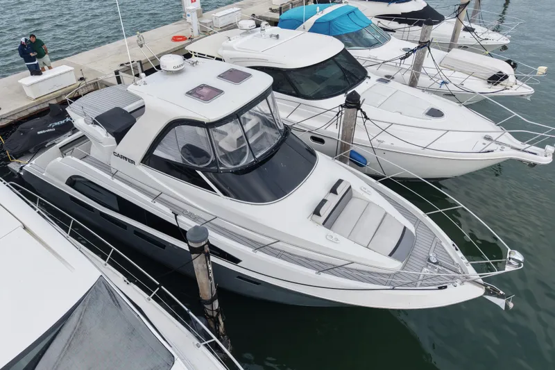 Slide: The Image of 2009 Carver 44 Sojourn yacht docked at marina, surrounded by other boats. - 6