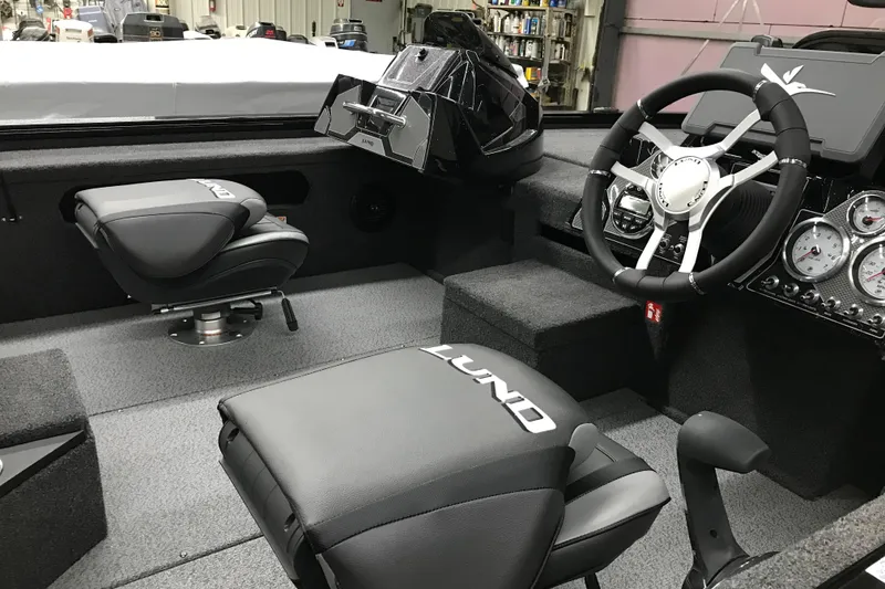 Slide: The Image of 2026 Lund 1875 Pro-V Bass XS interior with steering wheel and seating. - 16