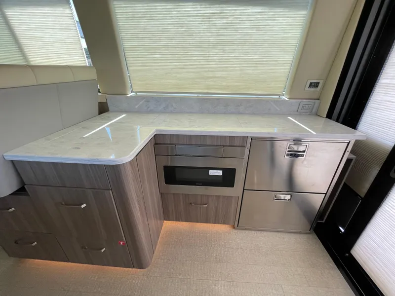 Slide: The Image of Modern kitchen area in 2022 Regal 42 FXO yacht with sleek cabinetry and appliances. - 11