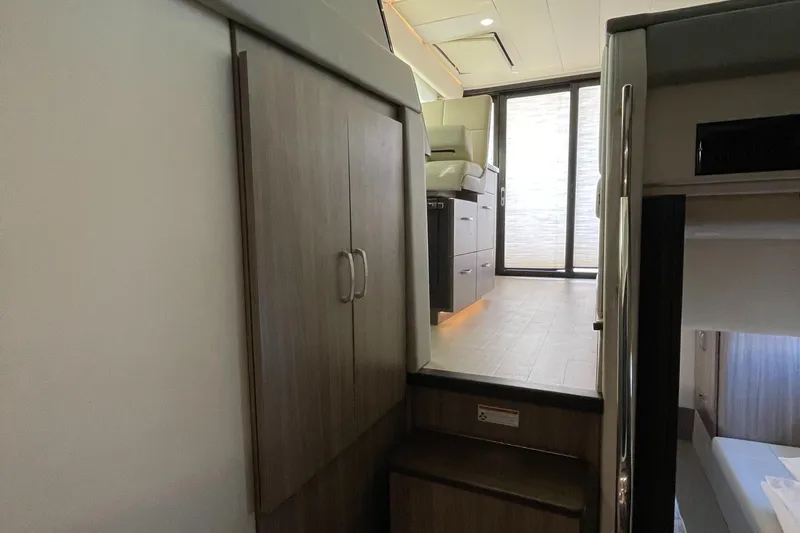 Slide: The Image of Interior of 2022 Regal 42 FXO yacht, featuring modern cabinetry and seating area. - 15