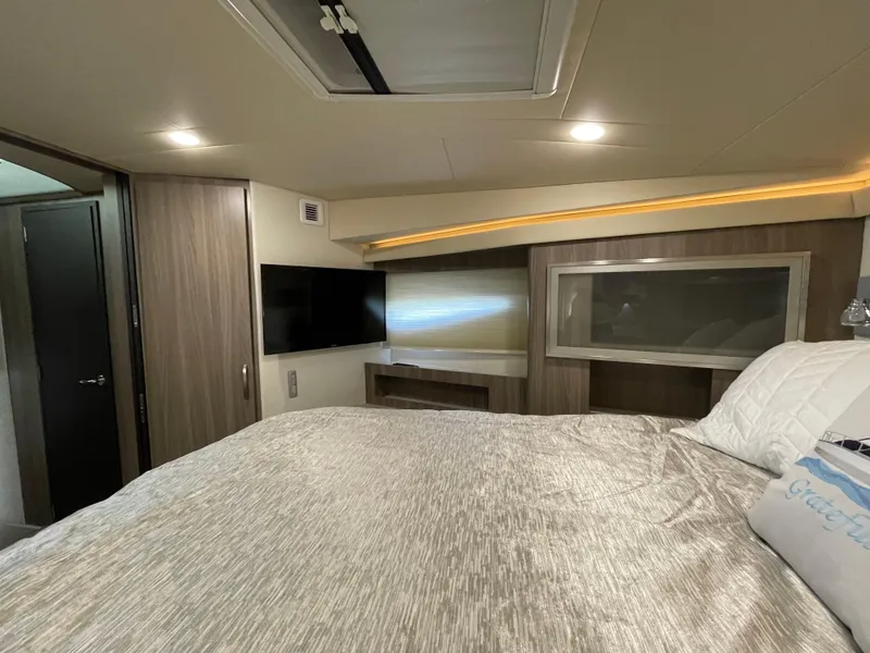 Slide: The Image of Luxurious interior of 2022 Regal 42 FXO yacht with modern amenities and cozy bedding. - 17