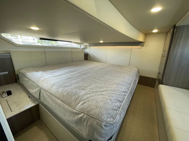 Slide: The Image of Luxurious cabin interior of 2022 Regal 42 FXO yacht with spacious bed. - 25