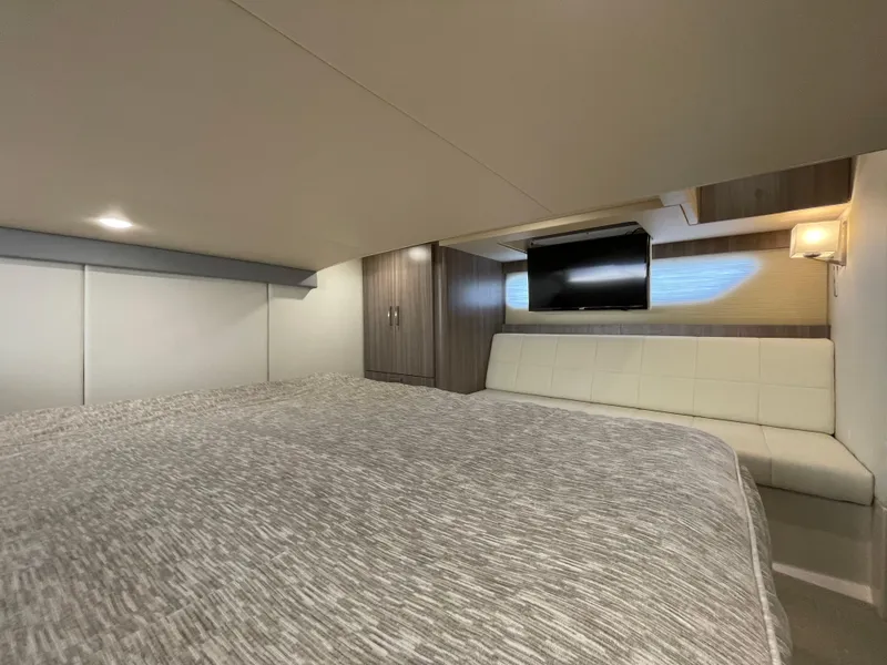 Slide: The Image of Luxurious interior of 2022 Regal 42 FXO yacht with cozy bed and TV. - 27