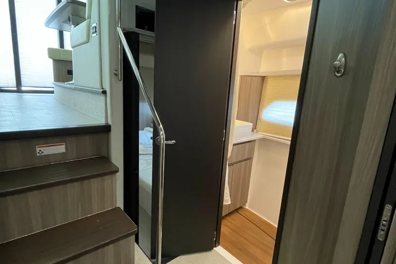 Slide: The Image of Interior of 2022 Regal 42 FXO yacht, featuring stairs and modern cabin design. - 30