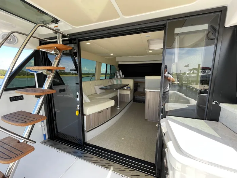 Slide: The Image of 2022 Regal 42 FXO yacht interior with modern seating and sleek design. - 39