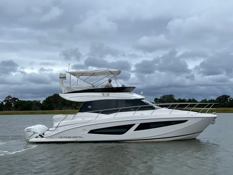 Slide: The Image of 2022 Regal 42 FXO yacht cruising on a cloudy day. - 4