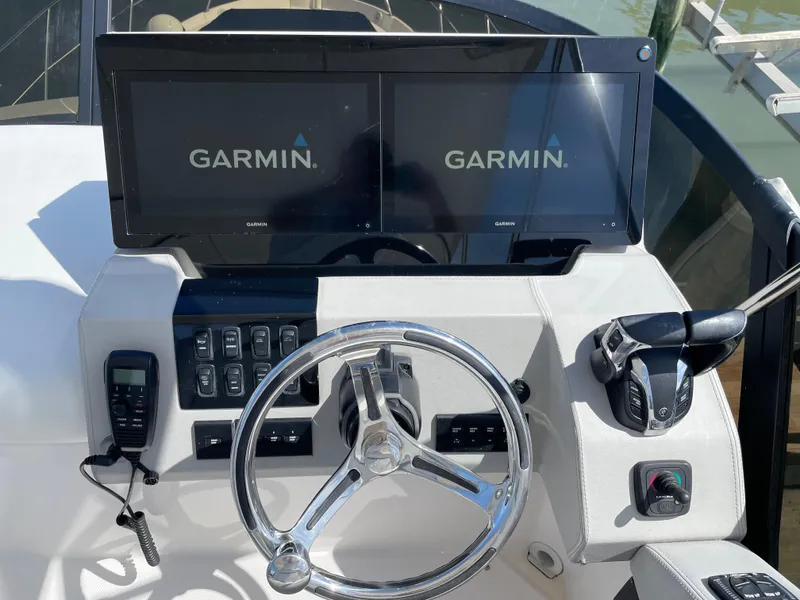 Slide: The Image of 2022 Regal 42 FXO helm with dual Garmin displays and controls. - 48