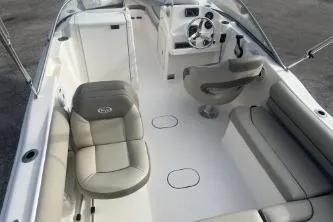 Slide: The Image of 2024 Key West 203 DFS boat interior with seating and steering wheel, showcasing modern design. - 10