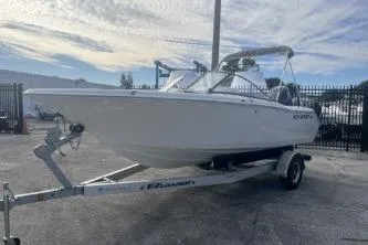 Slide: The Image of 2024 Key West 203 DFS boat on trailer, parked outdoors under a cloudy sky. - 3