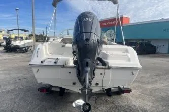 Slide: The Image of 2024 Key West 203 DFS boat with powerful outboard motor, displayed outdoors. - 5