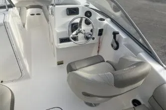 Slide: The Image of 2024 Key West 203 DFS boat interior with steering wheel and seating. - 6