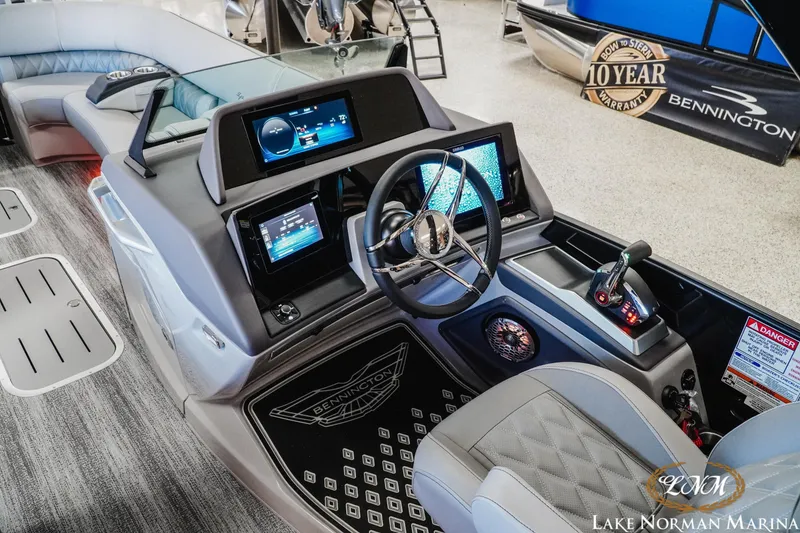 Slide: The Image of 2026 Bennington 25QSBA boat interior with modern dashboard and steering wheel at Lake Norman Marina. - 10