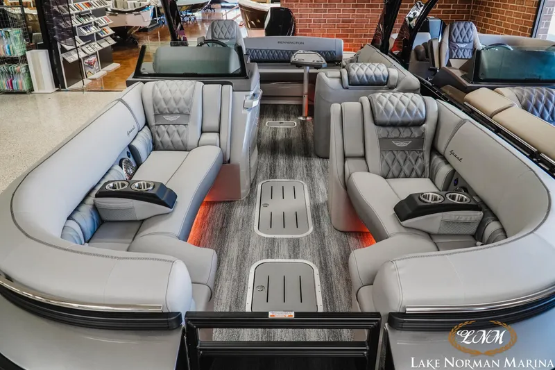 Slide: The Image of 2026 Bennington 25QSBA luxury pontoon boat interior with plush seating and modern design. - 13