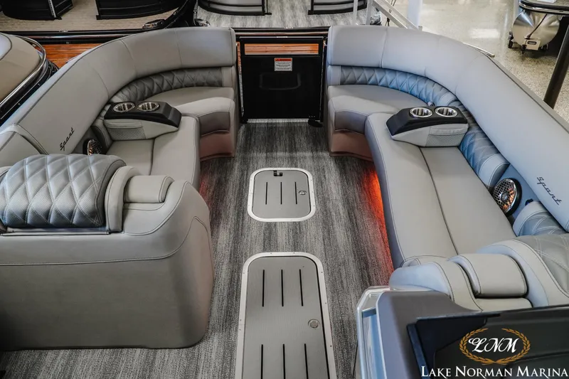 Slide: The Image of Luxurious interior of 2026 Bennington 25QSBA pontoon boat with plush seating and cup holders. - 3