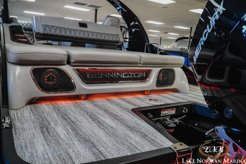 Slide: The Image of 2026 Bennington 25QSBA boat interior with stylish seating and ambient lighting. - 5