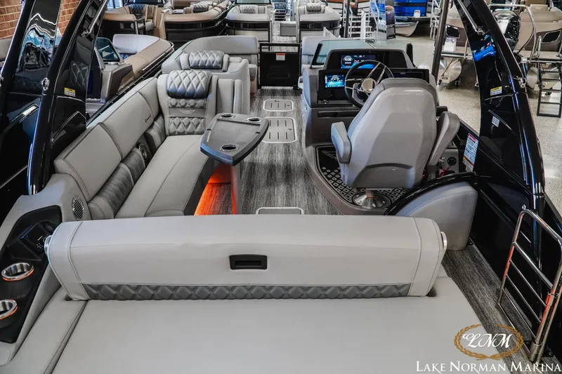 Slide: The Image of 2026 Bennington 25QSBA luxury pontoon boat interior with plush seating and modern helm. - 6