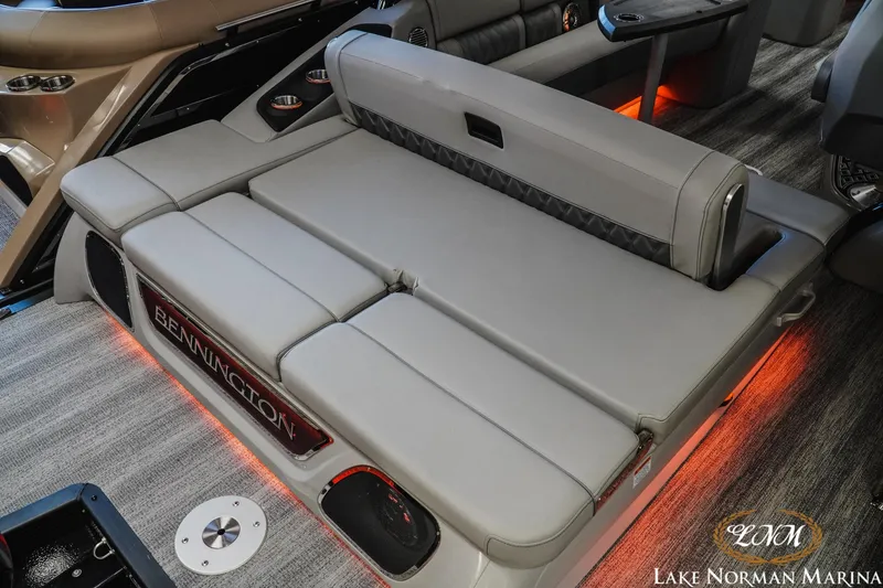 Slide: The Image of 2026 Bennington 25QSBA boat interior with luxurious seating and ambient lighting. - 7