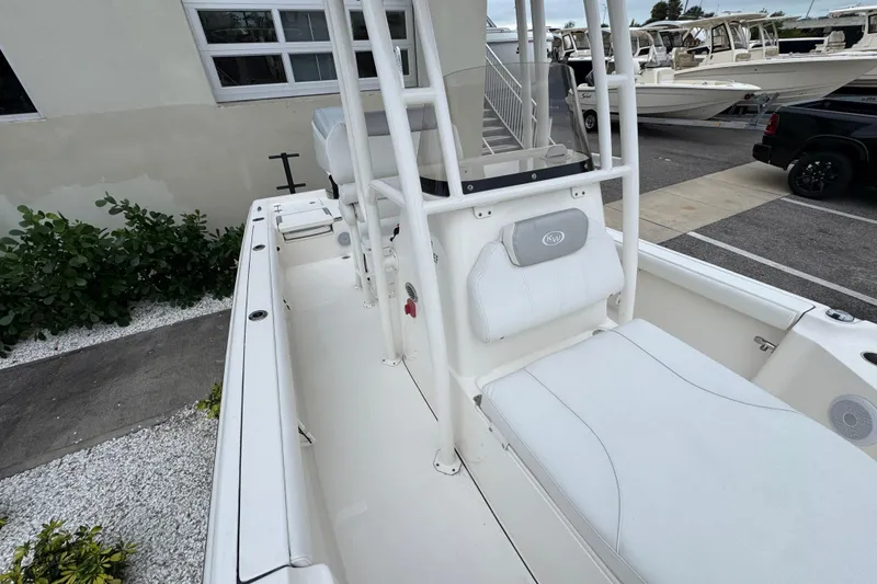 Slide: The Image of 2024 Key West 250 Bay Reef boat interior with white seating and console. - 10
