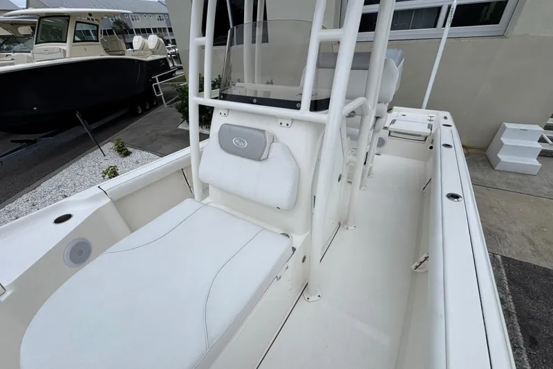 Slide: The Image of 2024 Key West 250 Bay Reef boat interior with white seating and console. - 11